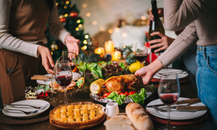holiday table with food including wine and pie